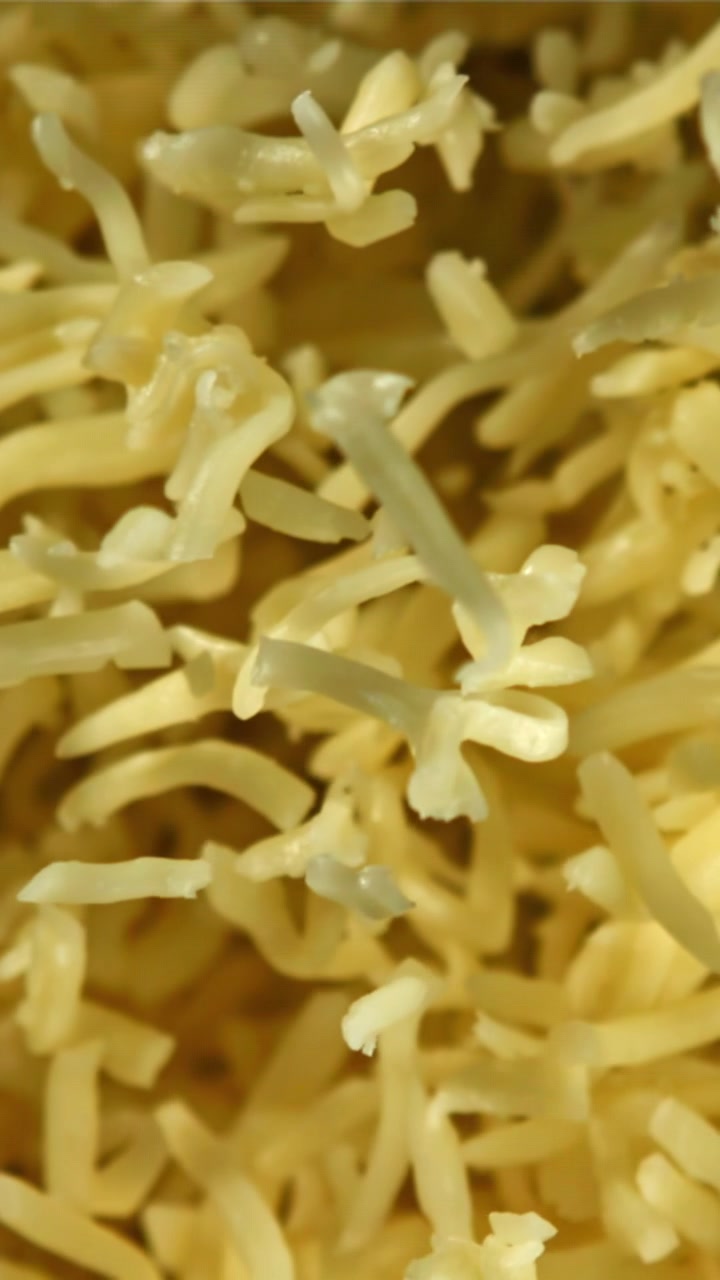 Close-up Macro Shot of Shredded Yellow Cheese