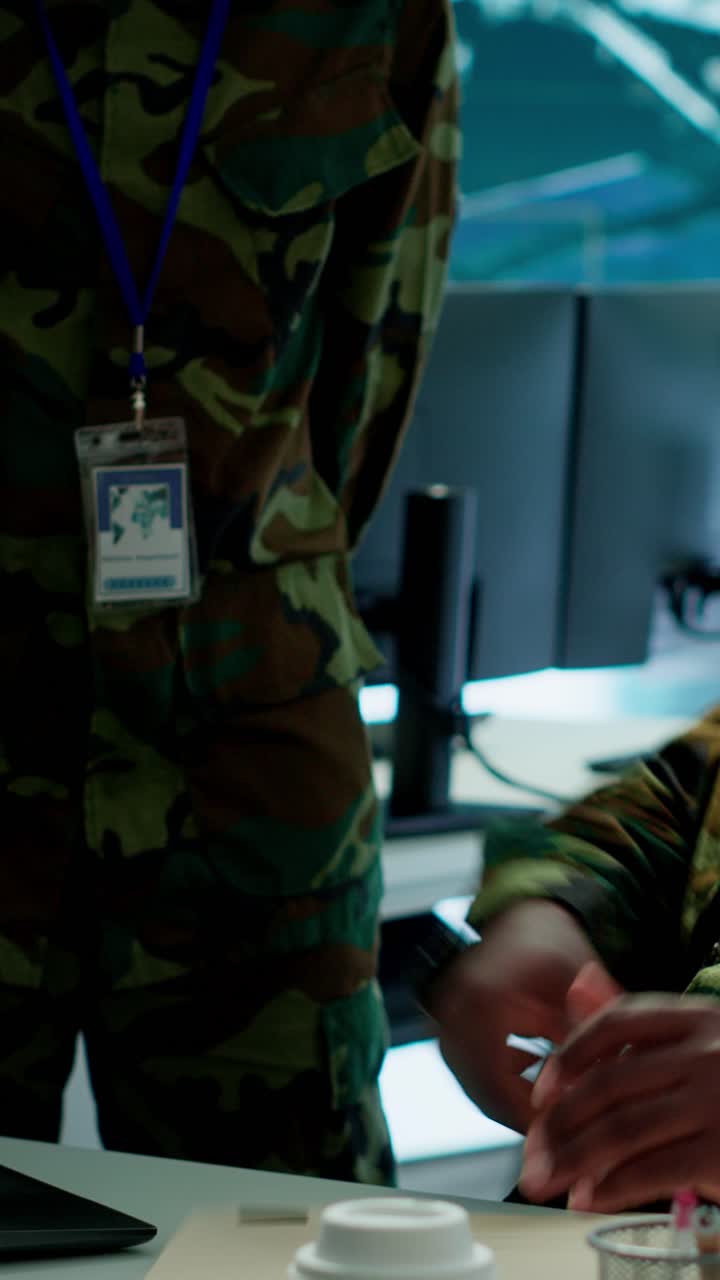 Vertical Video Angry army expert in a command post power base monitors satellite footage