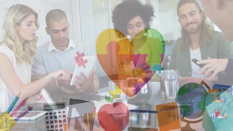 Animation-of-colourful-puzzle-pieces-heart-over-business-colleagues-with-electronic-devices