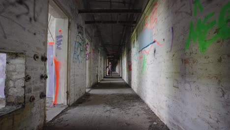 long extending corridor, man searching, investigating, observing, slow-mo