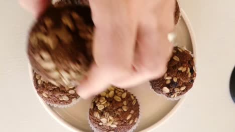 close-up of hand holding muffins