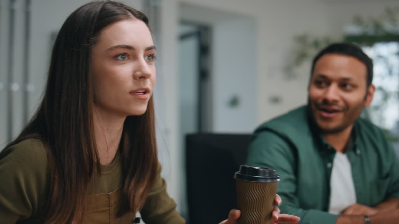 la gerente de la chica contando una historia divertida a los compañeros de oficina sentados juntos de cerca.