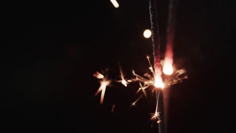 Video-of-close-up-of-sparklers-and-copy-space-on-black-background