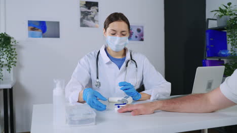 doctor examining patient with pulse oximeter
