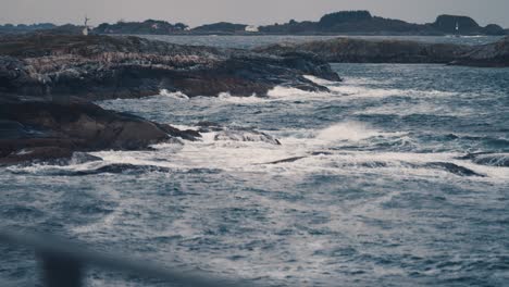 powerful waves are crashing on the rocky shores near the atlantic road, in norway