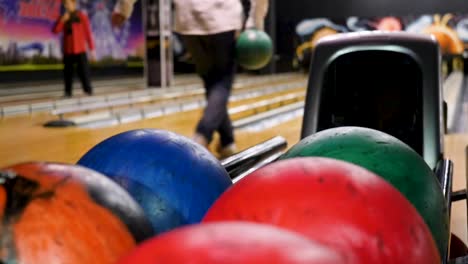 man placing bowling ball ready to bowl