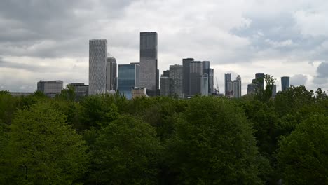 canary wharf skyline from across a green space