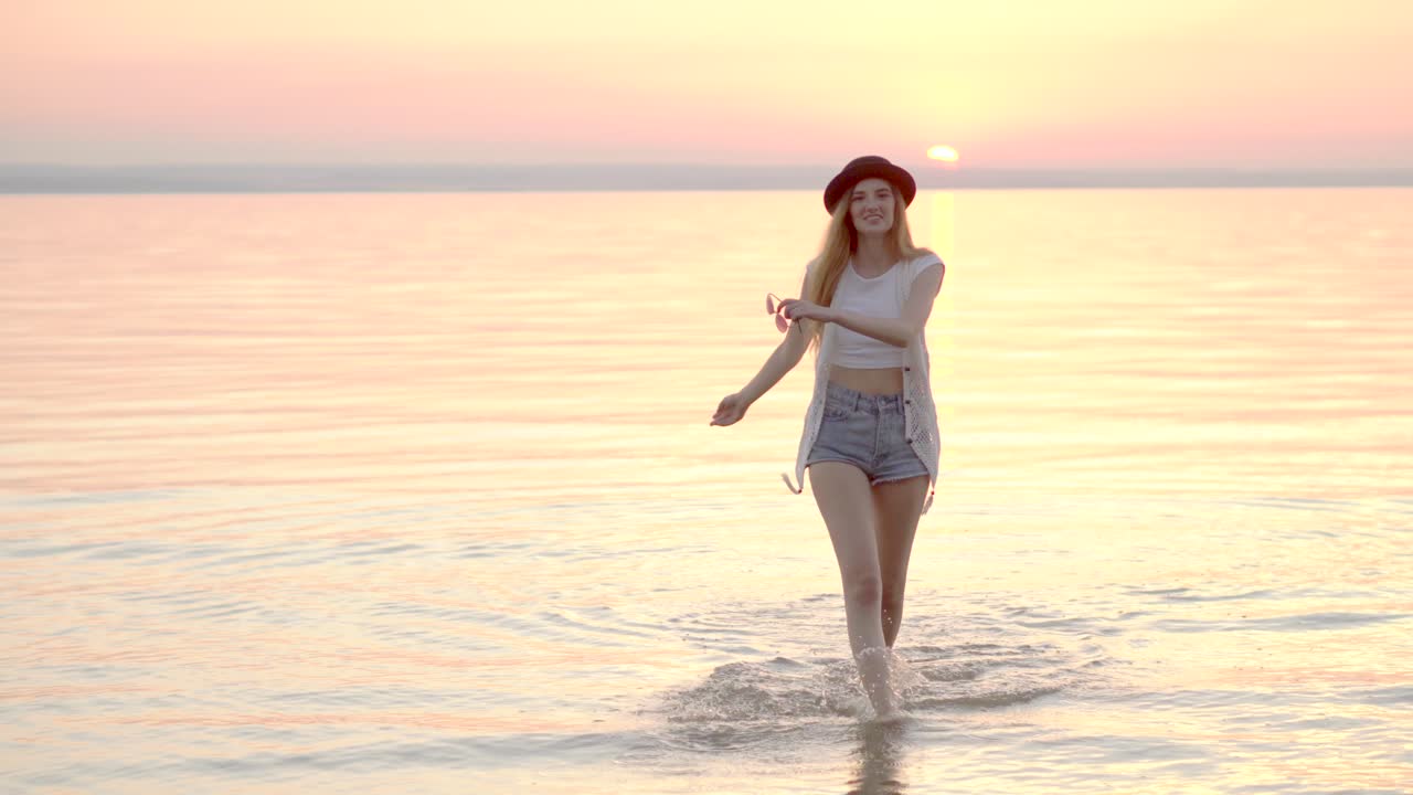 Woman Walking in Shallow Water at Sunrise
