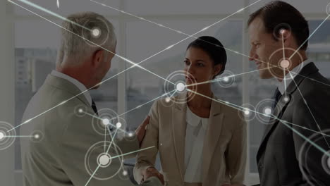 animation of network of connections with icons over diverse business people in office