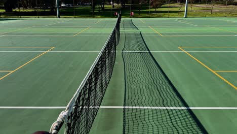 tennis court closeup net looking down line of multiple courts perth australia