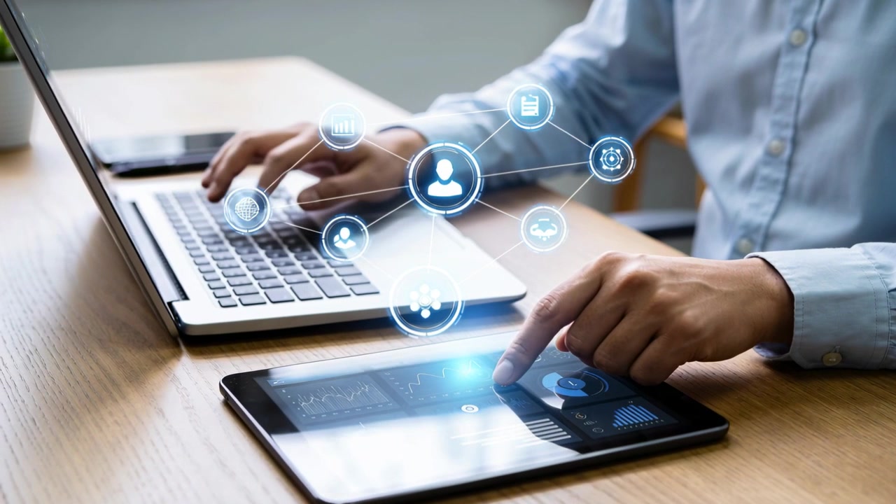 Tapping man in light blue shirt at desk, finger contacting tablet, raising network UI over laptop