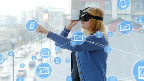 Animation-of-network-of-connections-with-icons-over-woman-wearing-vr-headset