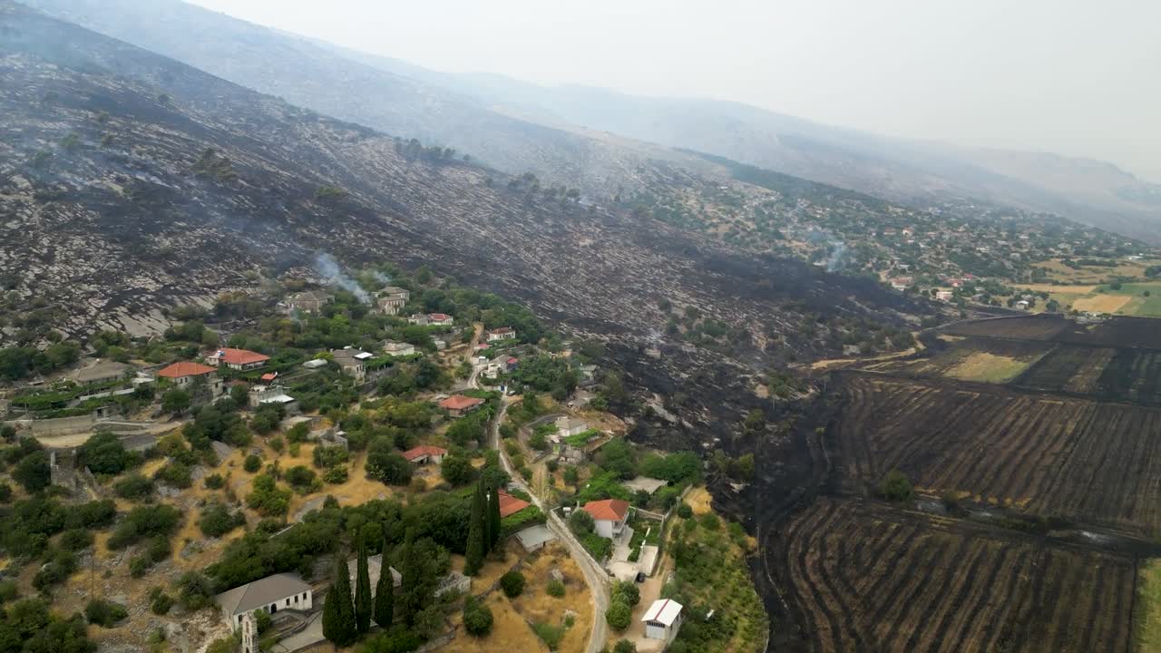 Aerial View of a Rural Village Bordering a Devastated Wildfire Landscape