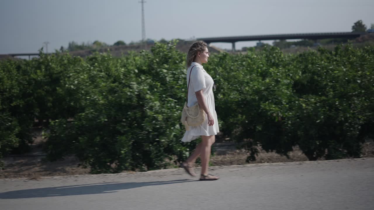 Woman Walking on Country Road