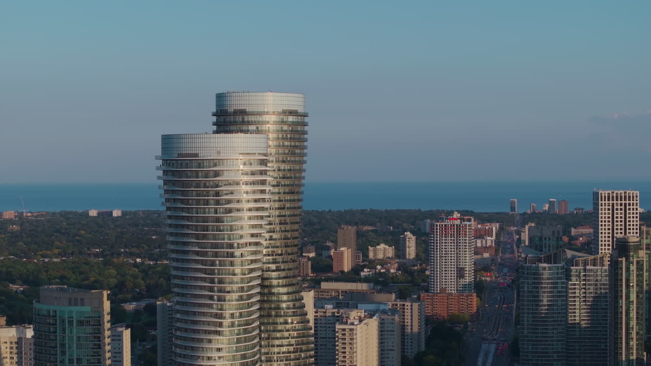 Curved towers in Mississauga cityscape at sunset, serene urban skyline