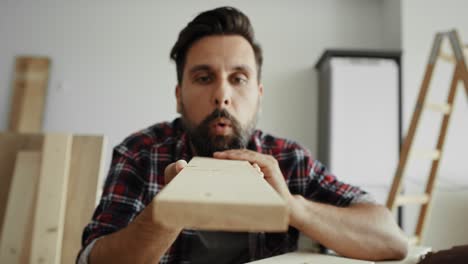 video of man using sandpaper for cleaning the board