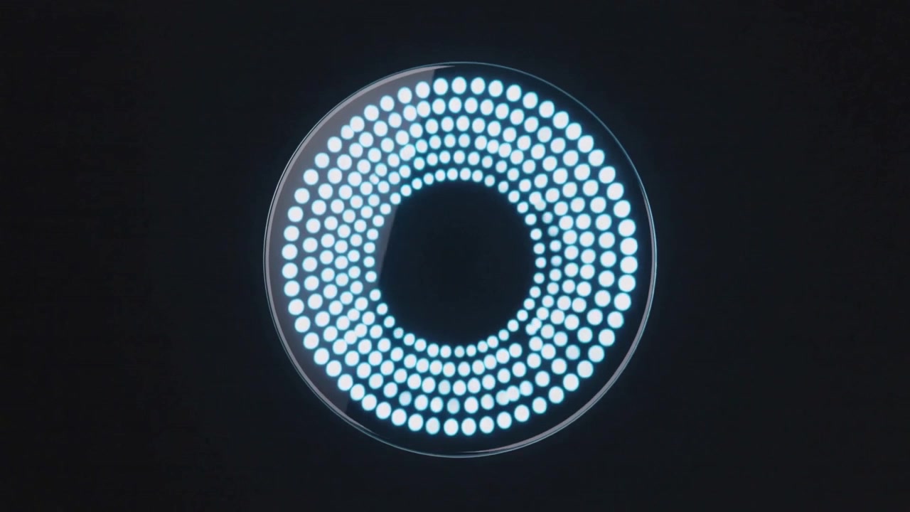 Powering circular glossy device expanding bluish LED rings on black field, indicating startup