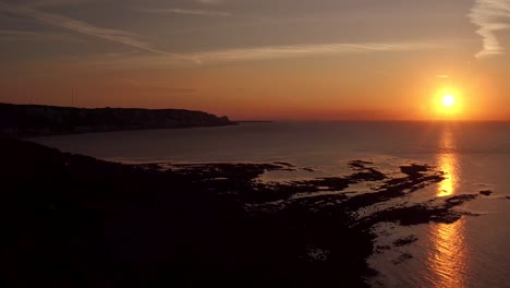 Sunny-sands-beach,-Folkestone,-UK-aerial-view-of-a-stunning-sunrise-over-a-deserted-beach