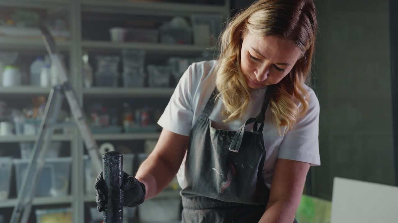 Woman mixing epoxy resin in art studio