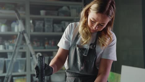 woman mixing epoxy resin in art studio