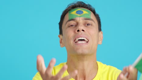 very nervous man supporting brazilian team during a difficult match