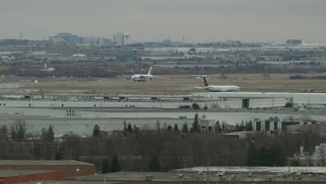 Citiycape-timelapse-view-of-an-airport-with-planes-moving,-industrial-and-polluted-landscape,-on-a-foggy-day