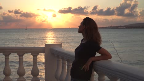 woman watching sunset by the sea