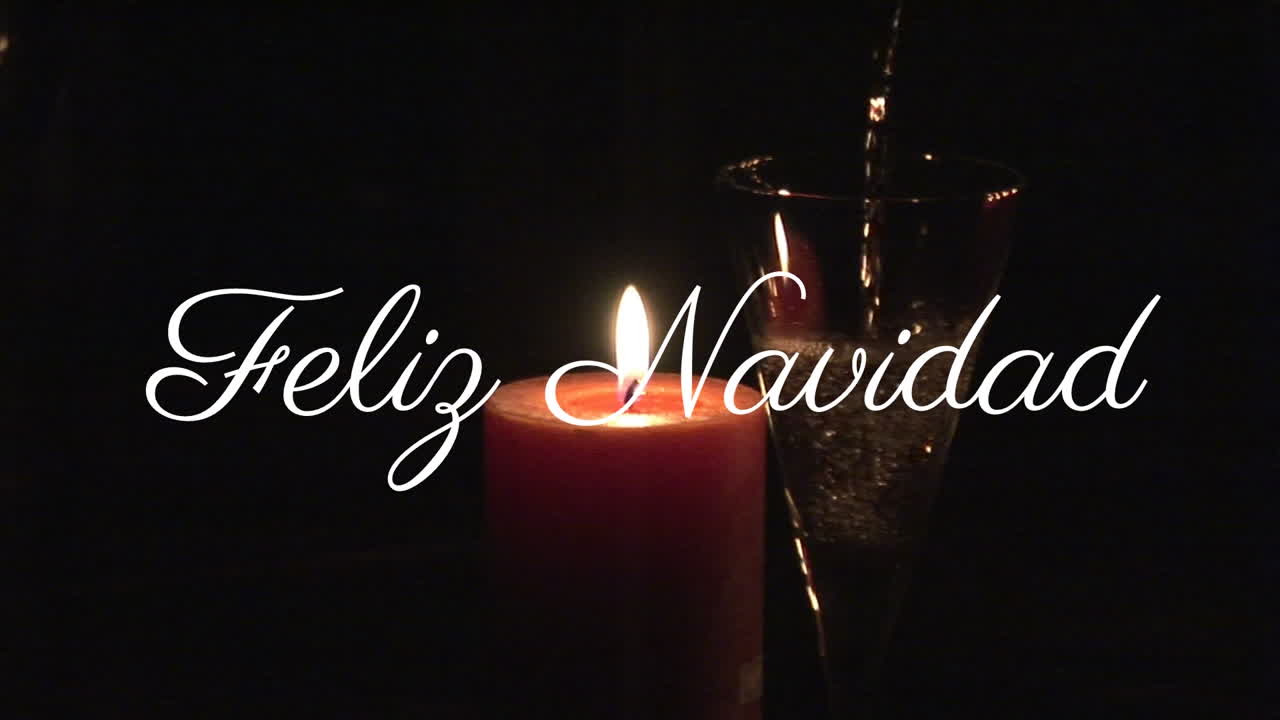 Feliz Navidad text animation over candle and champagne glass in dark background