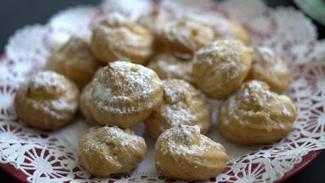 Pastries-with-powdered-sugar-on-plate-with-decorative-doily,-Closeup-Detail-Shot