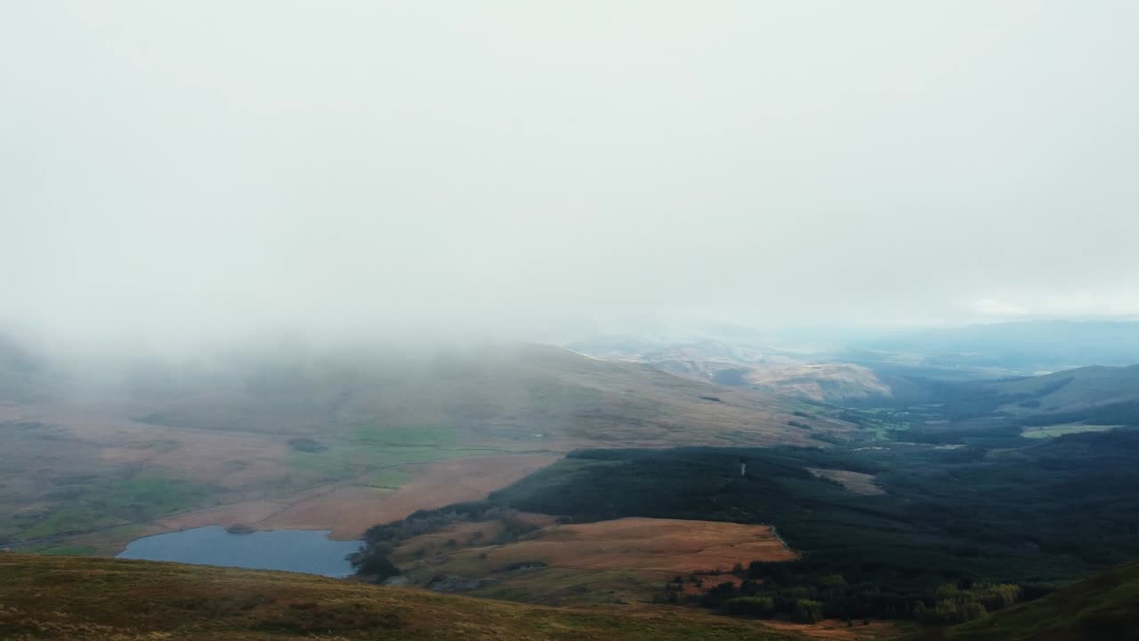 Aerial rotation flying through fog.fog covers the Snowdonia Mountain and hills landscape. Snowdonia,Wales,UK