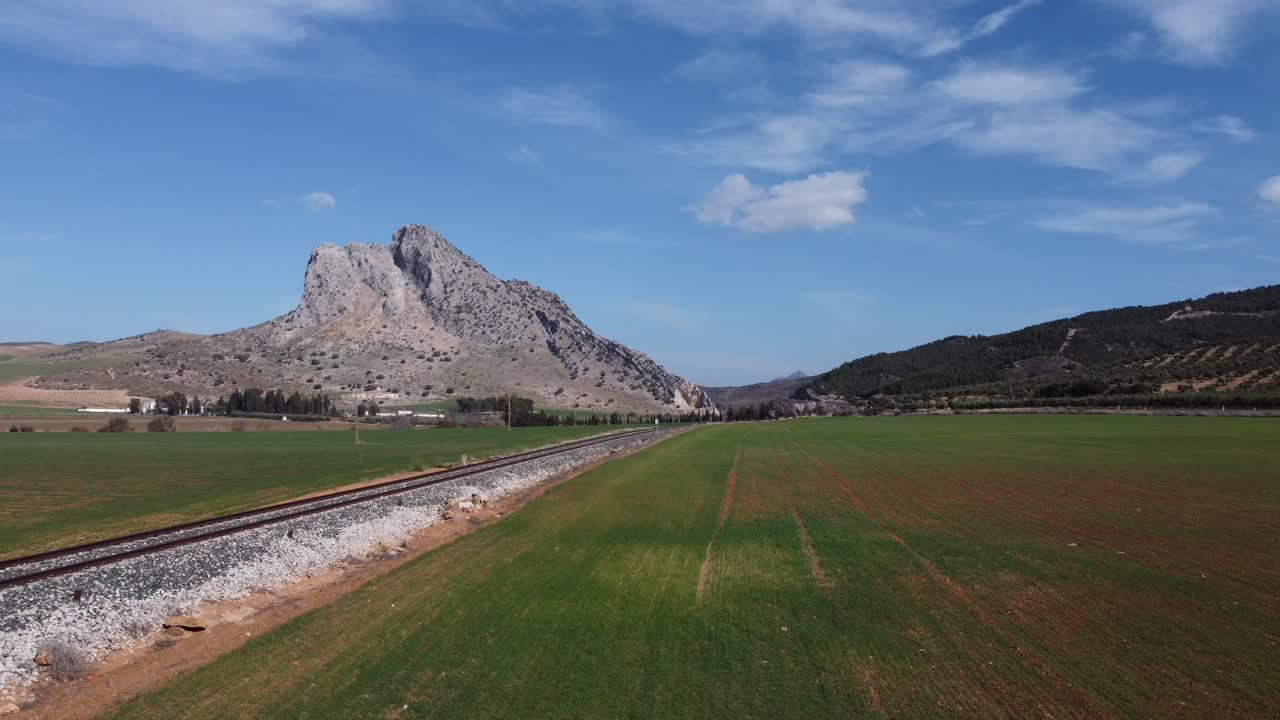 Spectacular aerial flight over the enclave of Pe&ntilde;a de los Enamorados, a rock formation in the shape of a human face in the municipality of Antequera in Andalusia, Spain