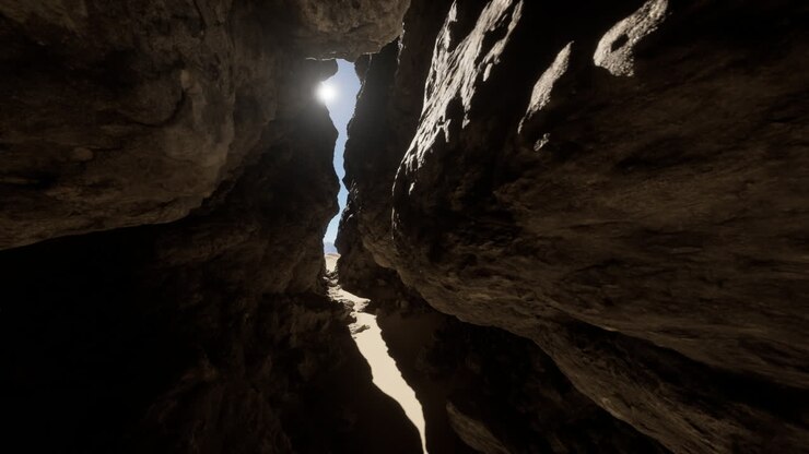A view through a narrow canyon, with sunlight shining through the rocks