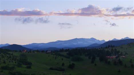 drone footage of a summer sunset over the mountains near boulder, colorado. aerial view of scenic wilderness, ridges, and forested landscapes.