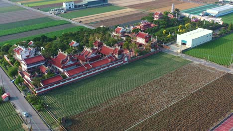 aerial flyover and around chifa matsu temple complex in the middle of agricultural fields, a sacred site dedicated to goddess of sea, a blend of cultural heritage and rural landscape, yunlin, taiwan