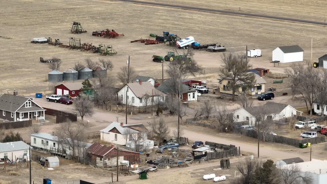 Briggsdale Colorado pan shot over homes and farm equipment
