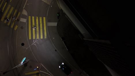 straight down aerial view of zurich, switzerland street with bus crossing at night