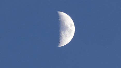 light blue sky, the crescent moon and moving clouds,