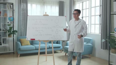 asian male teacher with glasses teaching chemist at home