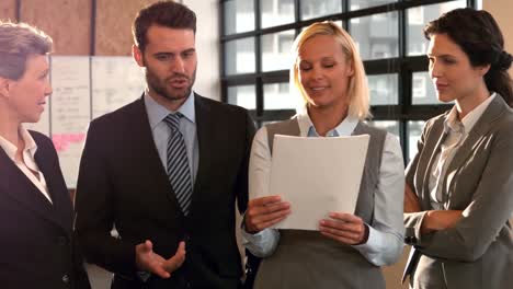 business people talking at holding documents