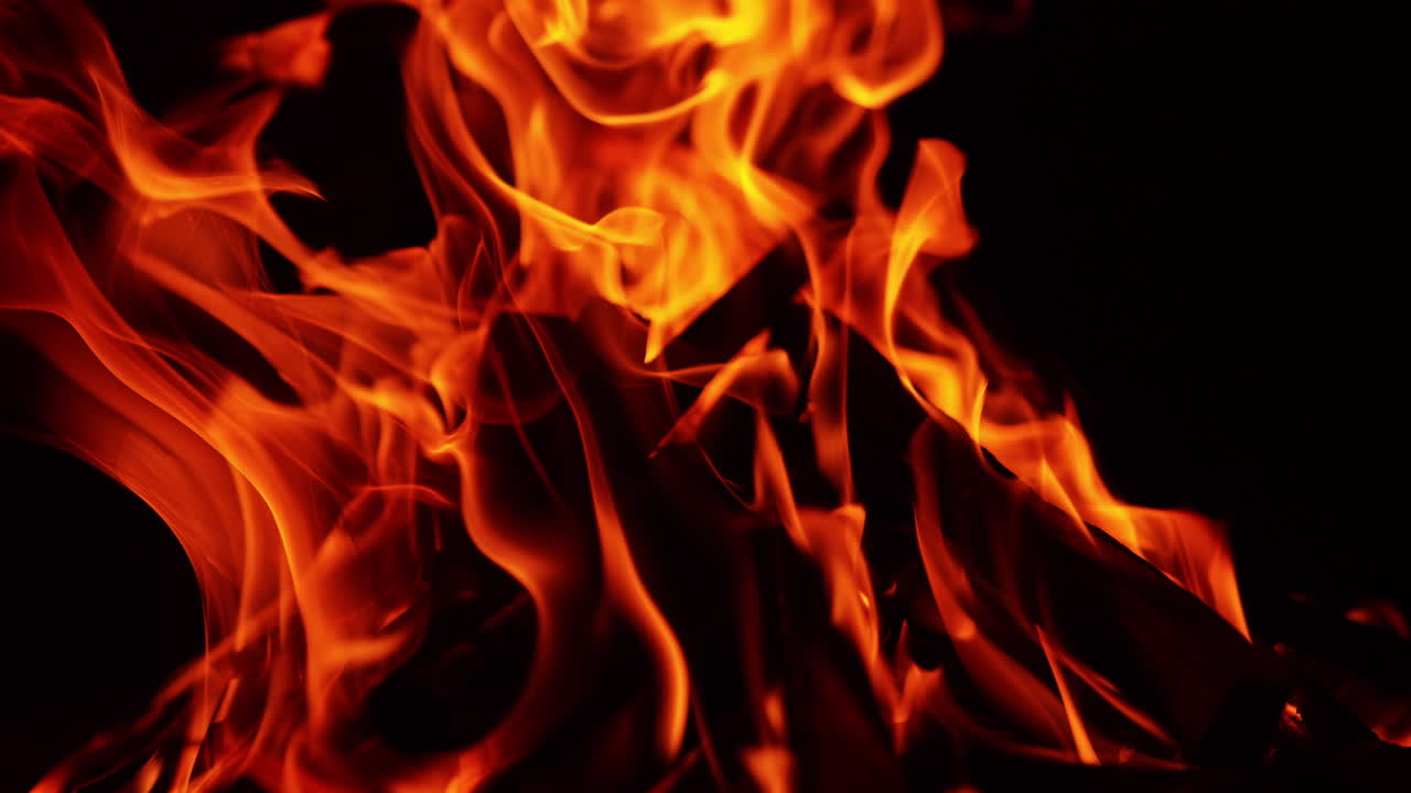 Cozy calming campfire burning peacefully at night. Close up view of the wood burning in bonfire.