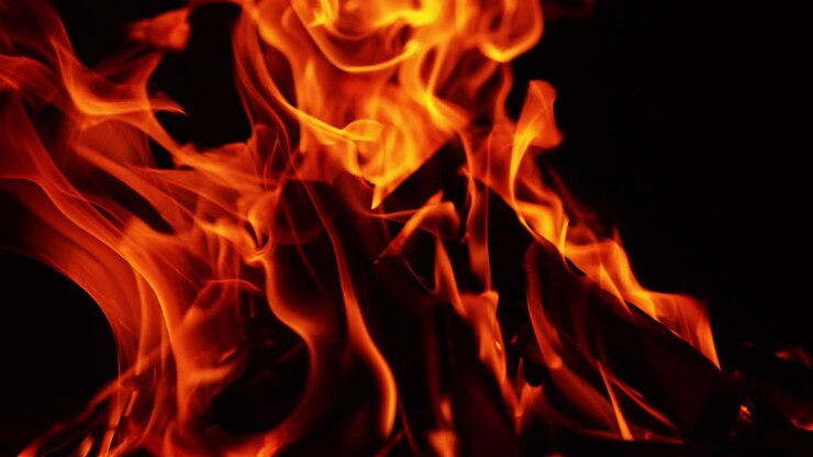 Cozy calming campfire burning peacefully at night. Close up view of the wood burning in bonfire.