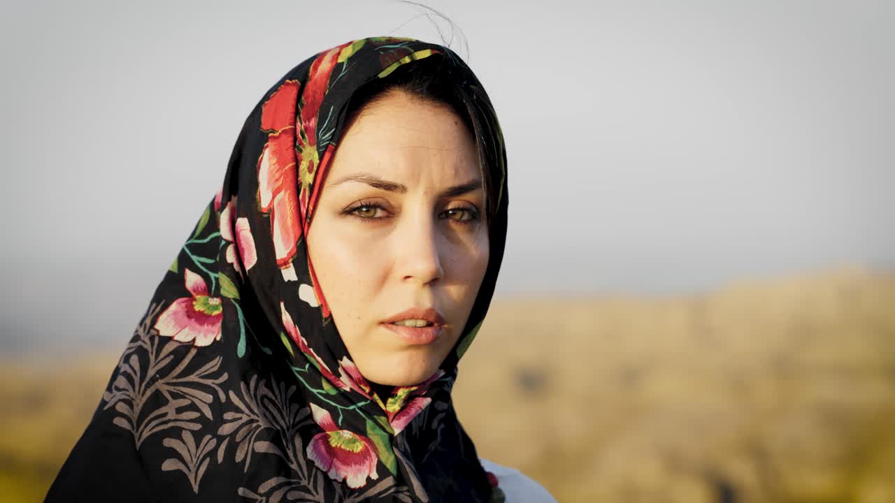 Beautiful muslim woman wearing a hijab looking at the camera outdoors