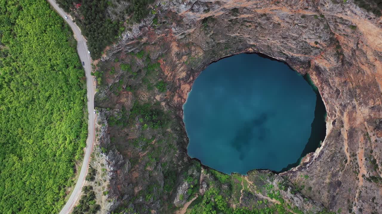 Bird's-eye view of circle shaped lake named red lake, Imotski, and lush nature