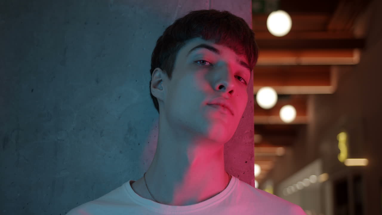 Portrait of a young man in neon light