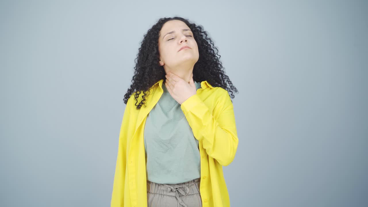 Young woman with sore throat.