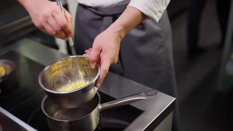 chef melting butter on water bath