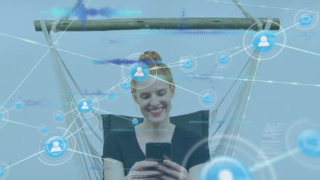Animation of network of connections over caucasian woman using smartphone