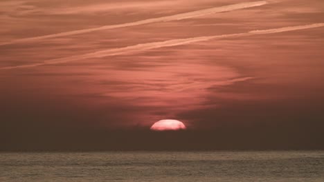 sol brillante saliendo sobre el cielo dramático sobre el mar durante el amanecer