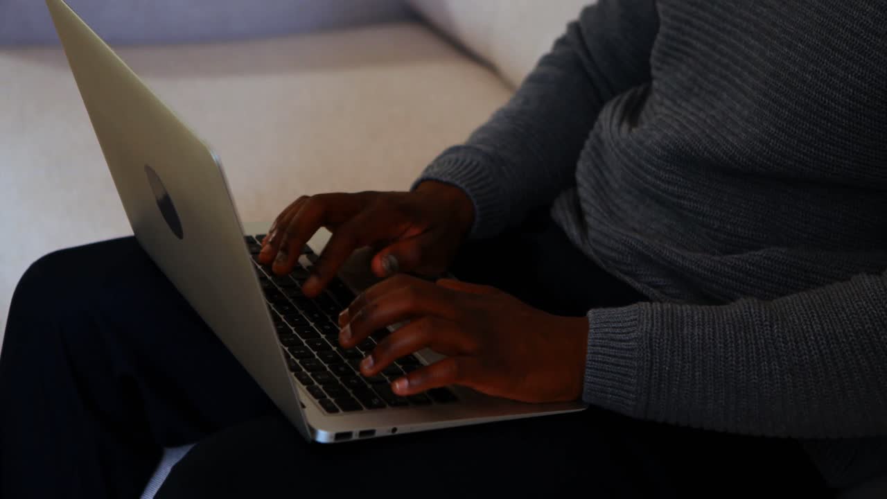 Male executive using laptop in office