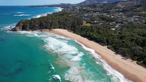 turquoise seascape of sapphire beach in new south wales, australia - aerial drone shot